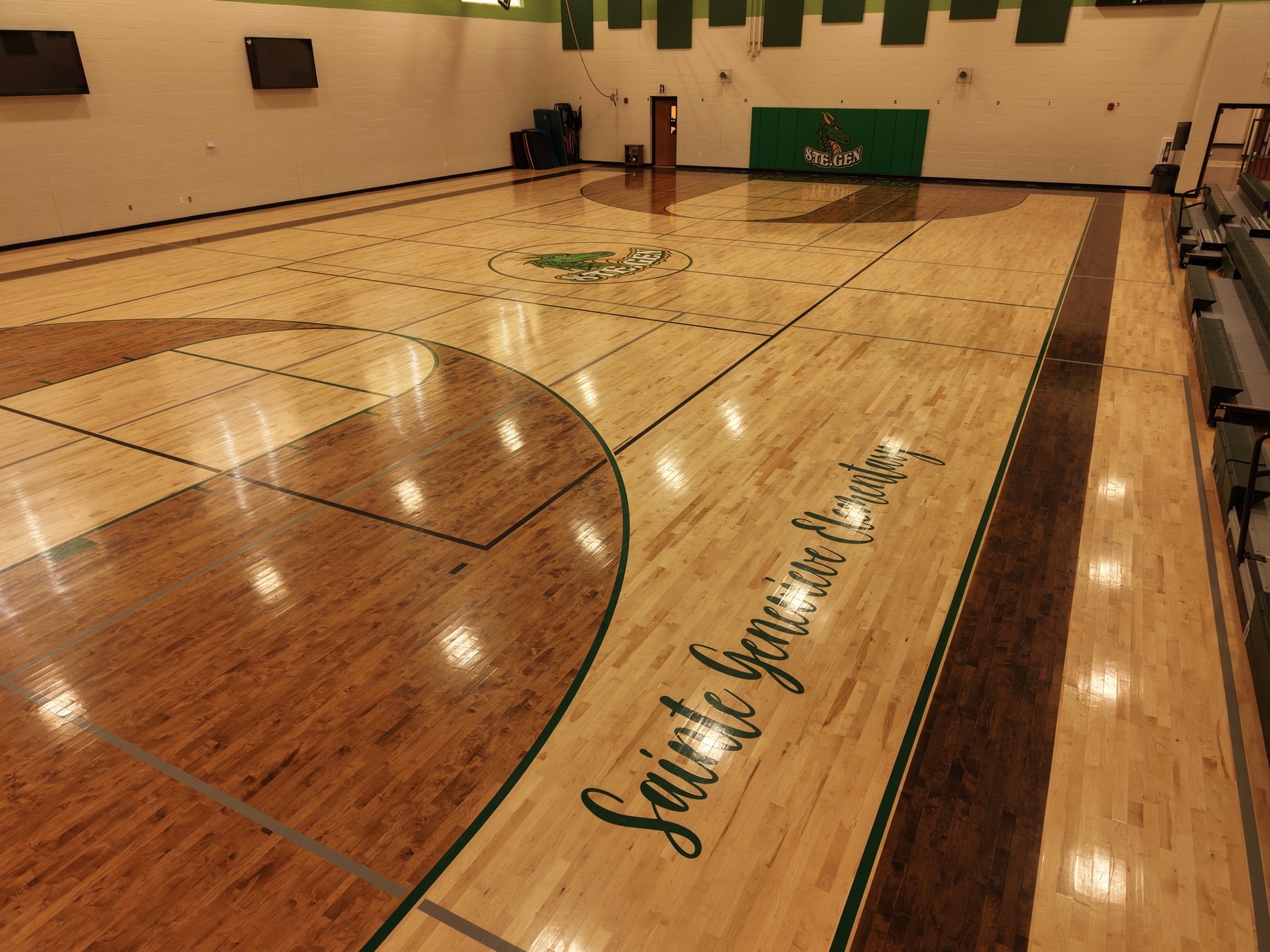 School gymnasium interior with custom court graphics - HelixMind Real Estate Media