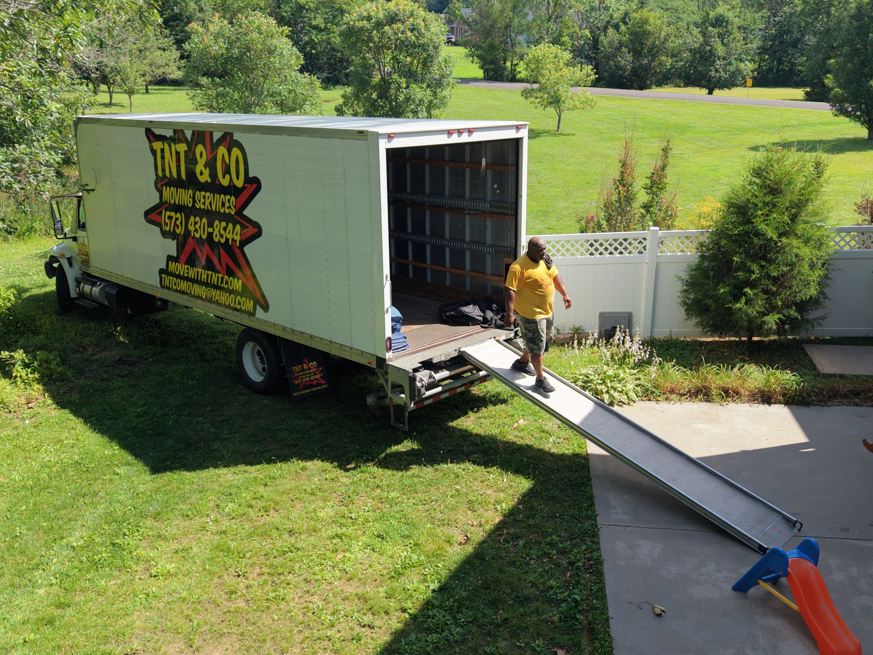 Moving crew unloading a moving truck on site - HelixMind Real Estate Media