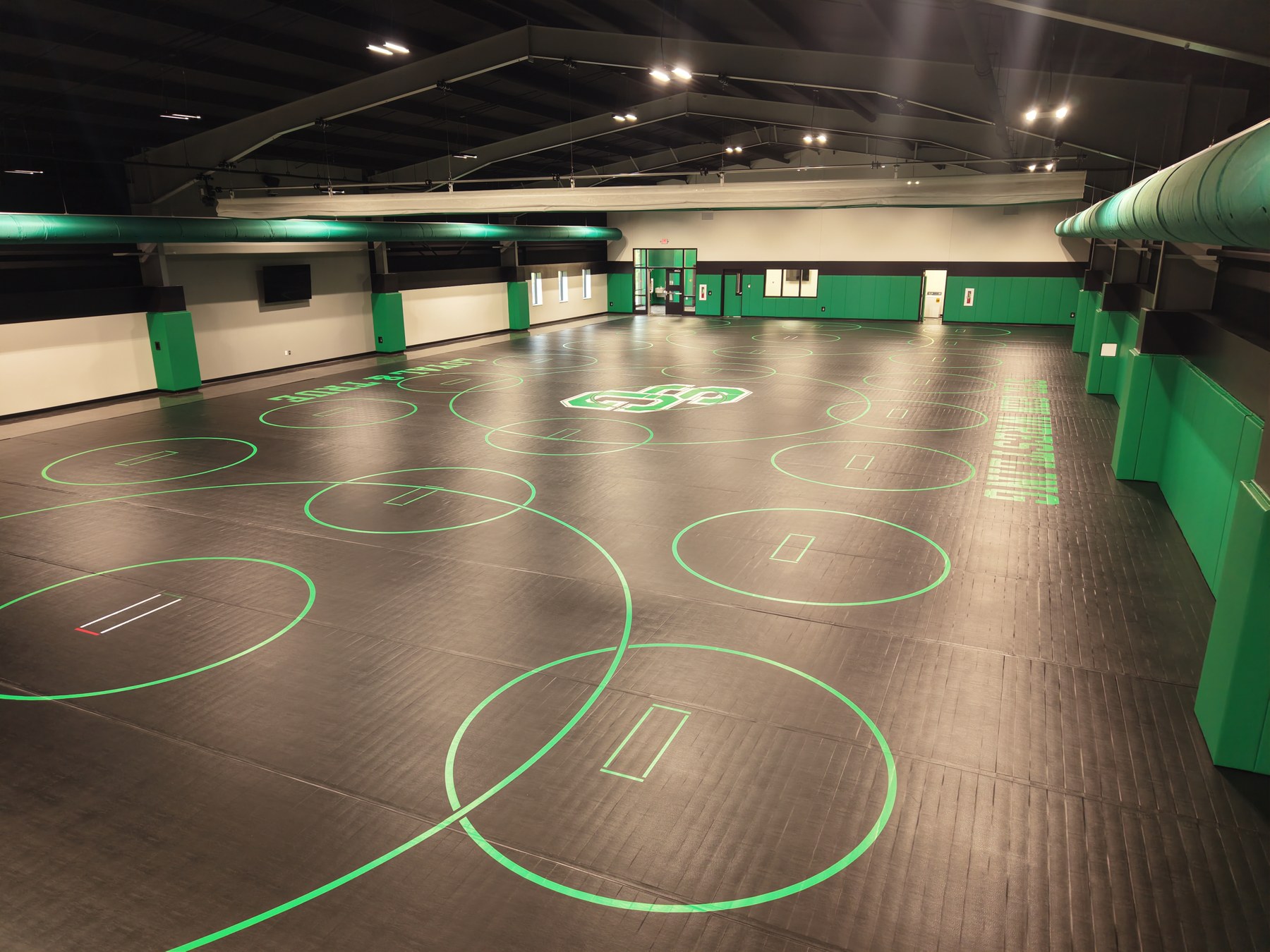 Indoor athletic training facility with custom floor graphics - HelixMind Real Estate Media