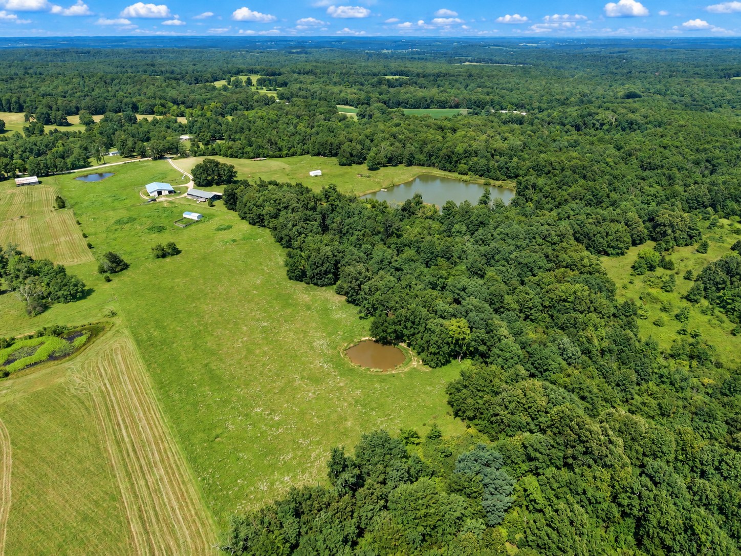 Aerial of farmland with barn and ponds - HelixMind Real Estate Media