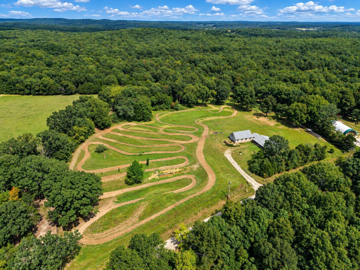 Aerial of motocross track carved into open field - HelixMind Real Estate Media