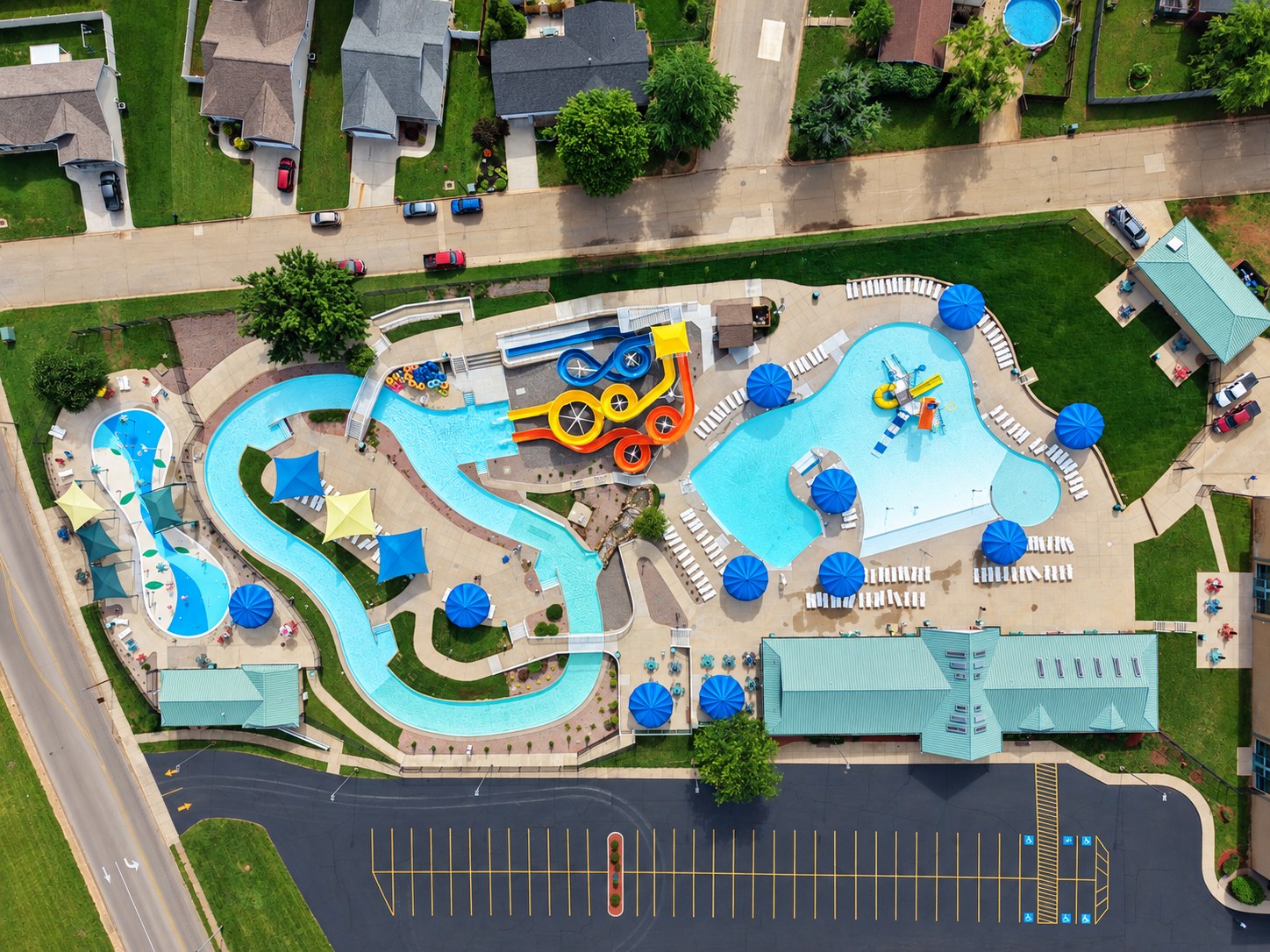 Wide aerial of water park and surrounding neighborhood - HelixMind Real Estate Media