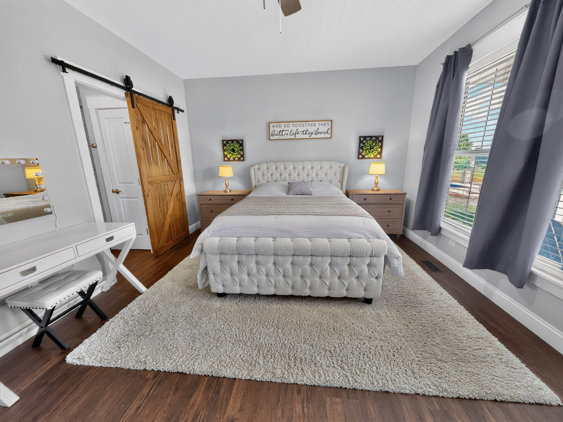 Styled bedroom with sliding barn door · Southeast Missouri - HelixMind Real Estate Media