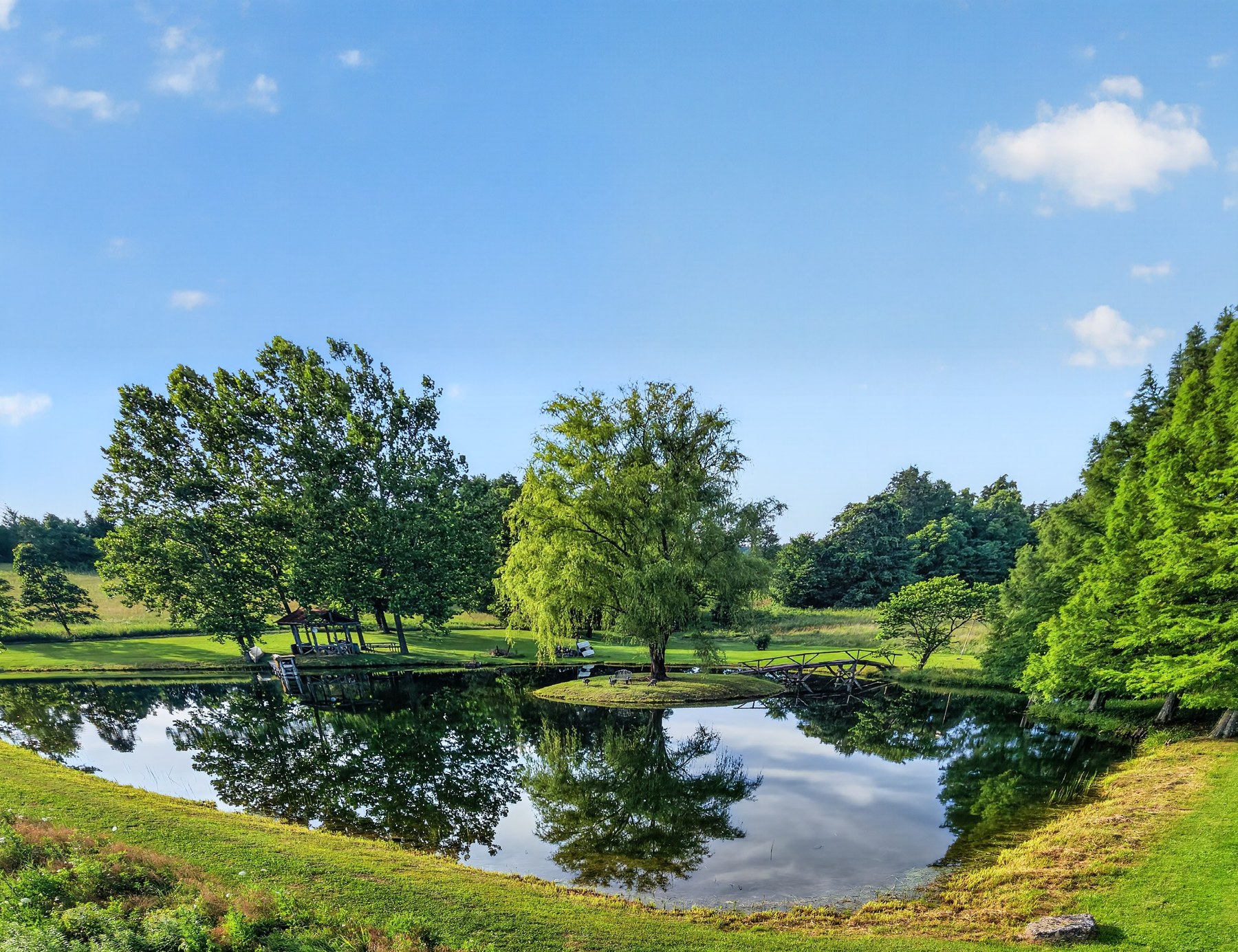 Pond with footbridge and gazebo · Southeast Missouri - HelixMind Real Estate Media