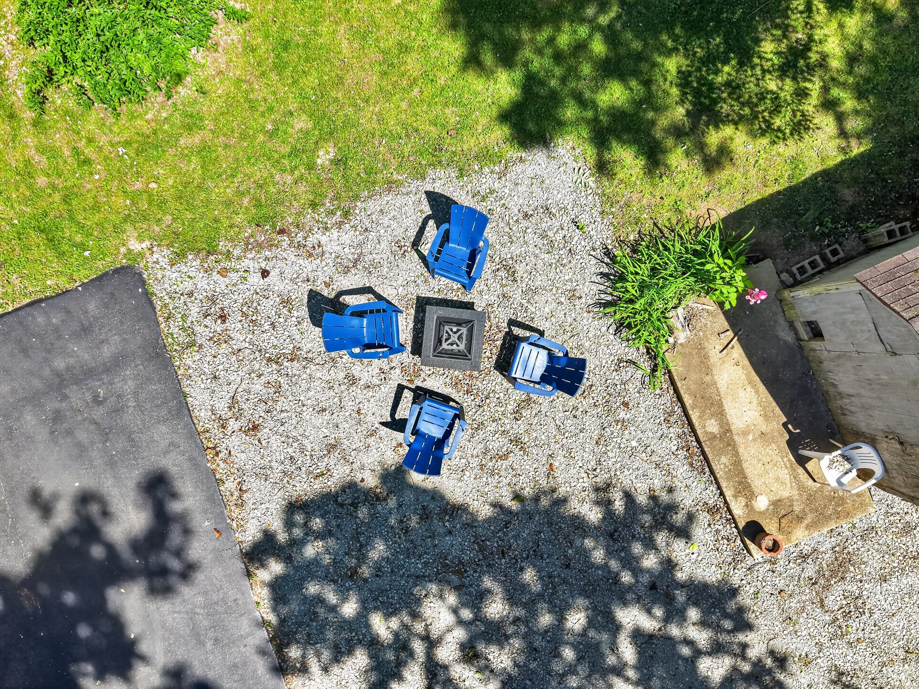 Aerial view of fire pit seating area in backyard - HelixMind Real Estate Media