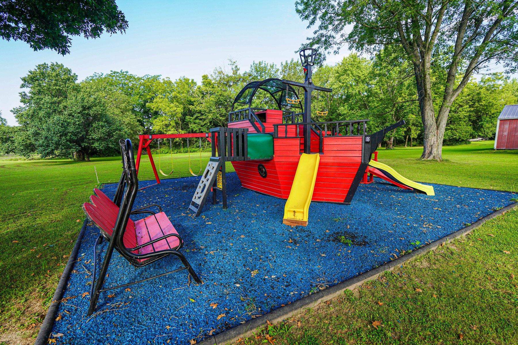 Backyard pirate ship playset with slides and swings - HelixMind Real Estate Media