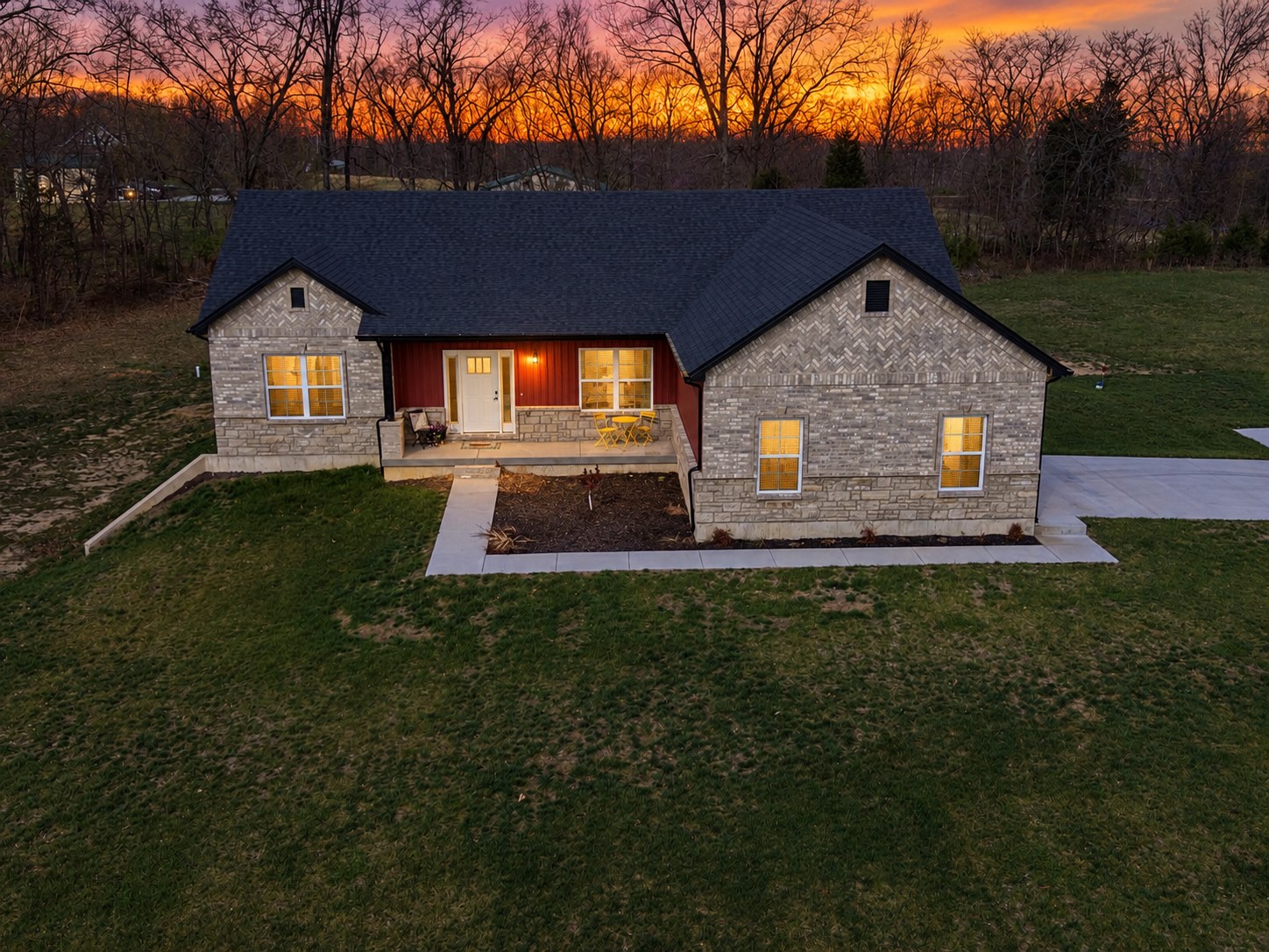 New construction home at sunset with warm interior lighting - HelixMind Real Estate Media
